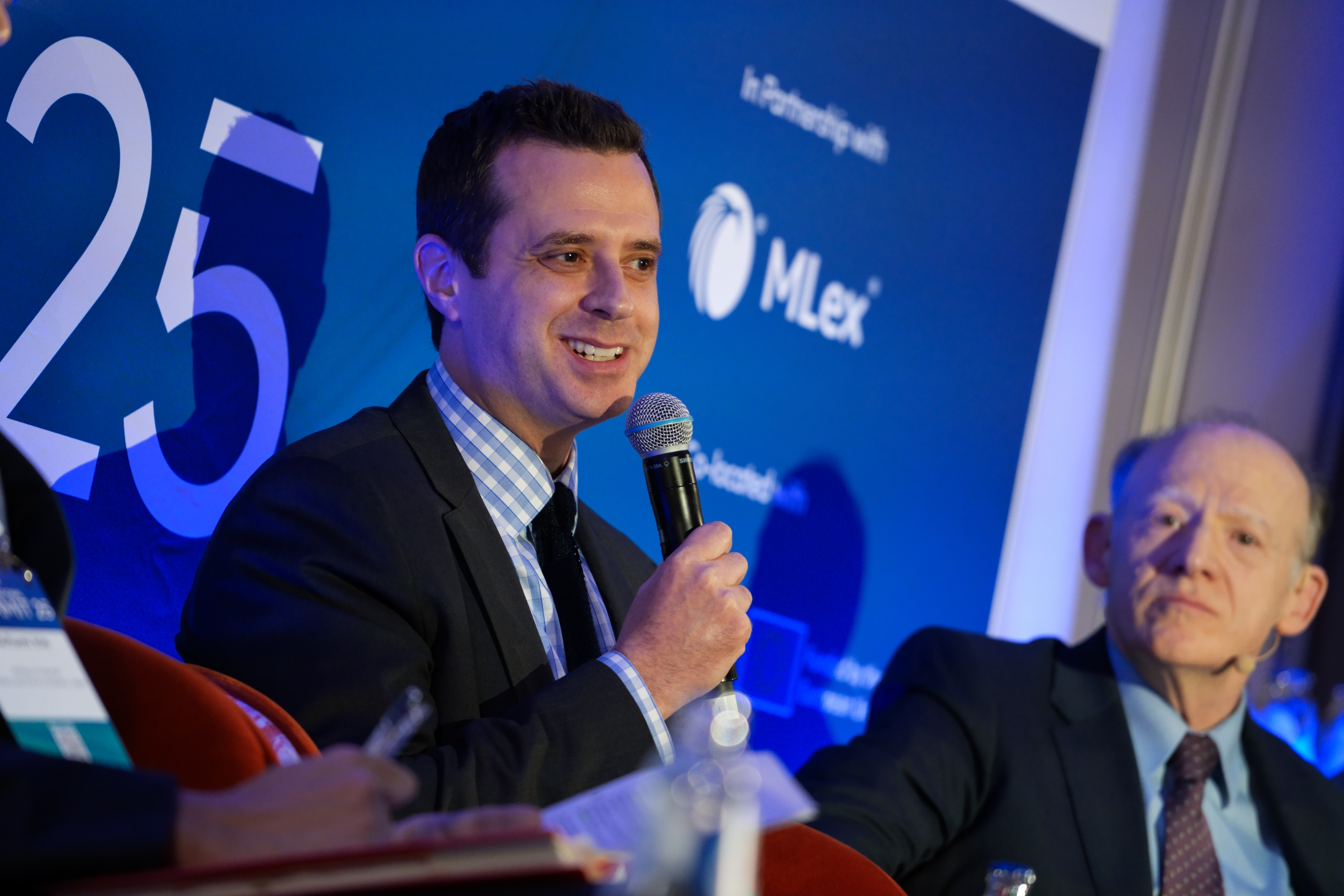 Atlassian&rsquo;s Aaron Kleiner on stage at the International AI Summit 2025.